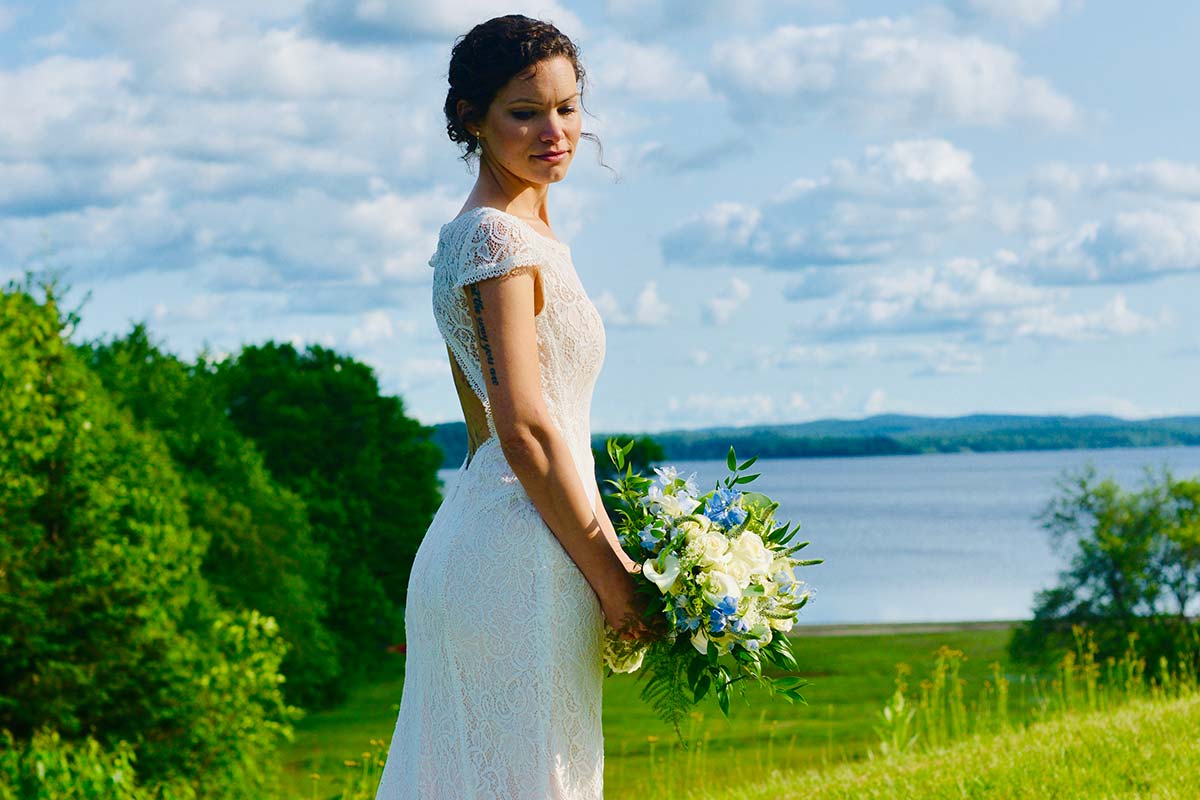 Bride posing in front of lake view